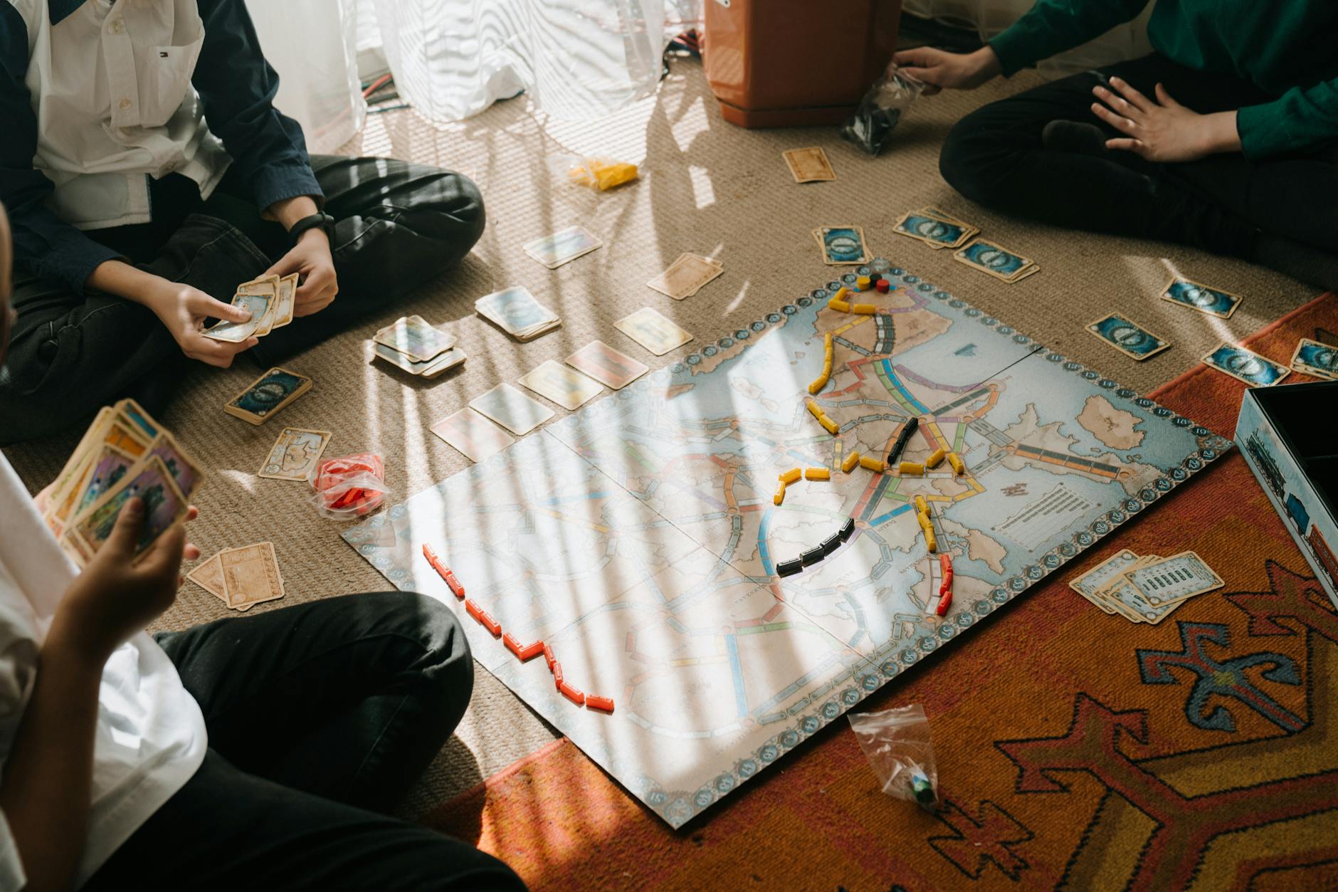 Cairo gaming table covered with Euro board game components, cards, and wooden tokens